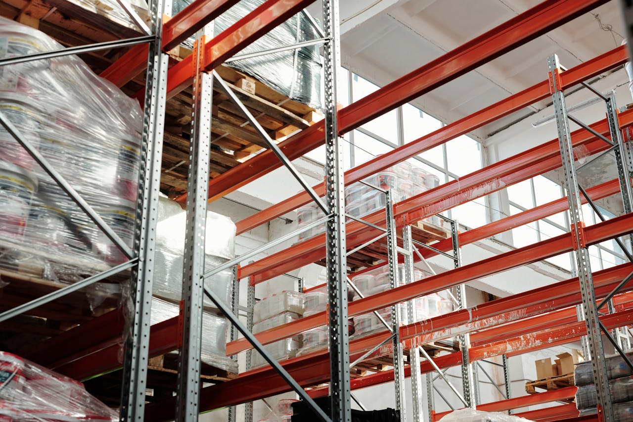 services-01 Bright modern warehouse featuring pallets and storage racks for logistics and inventory management.